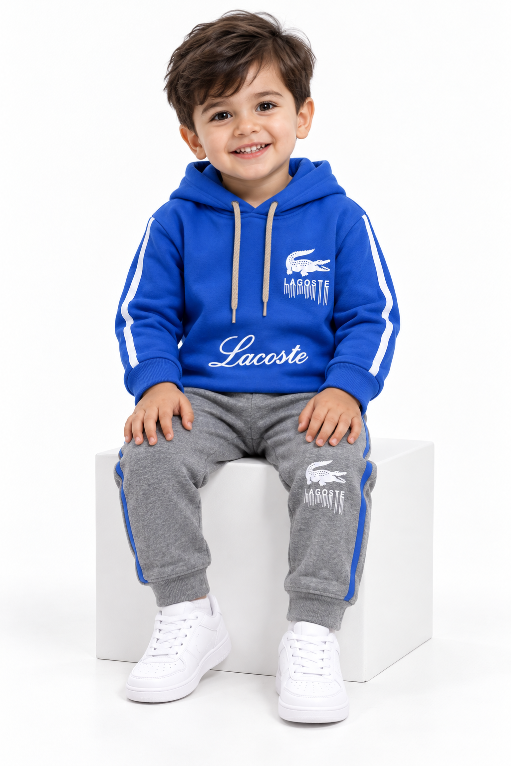 Toddler boy blue hoodie and grey jogger tracksuit sitting view