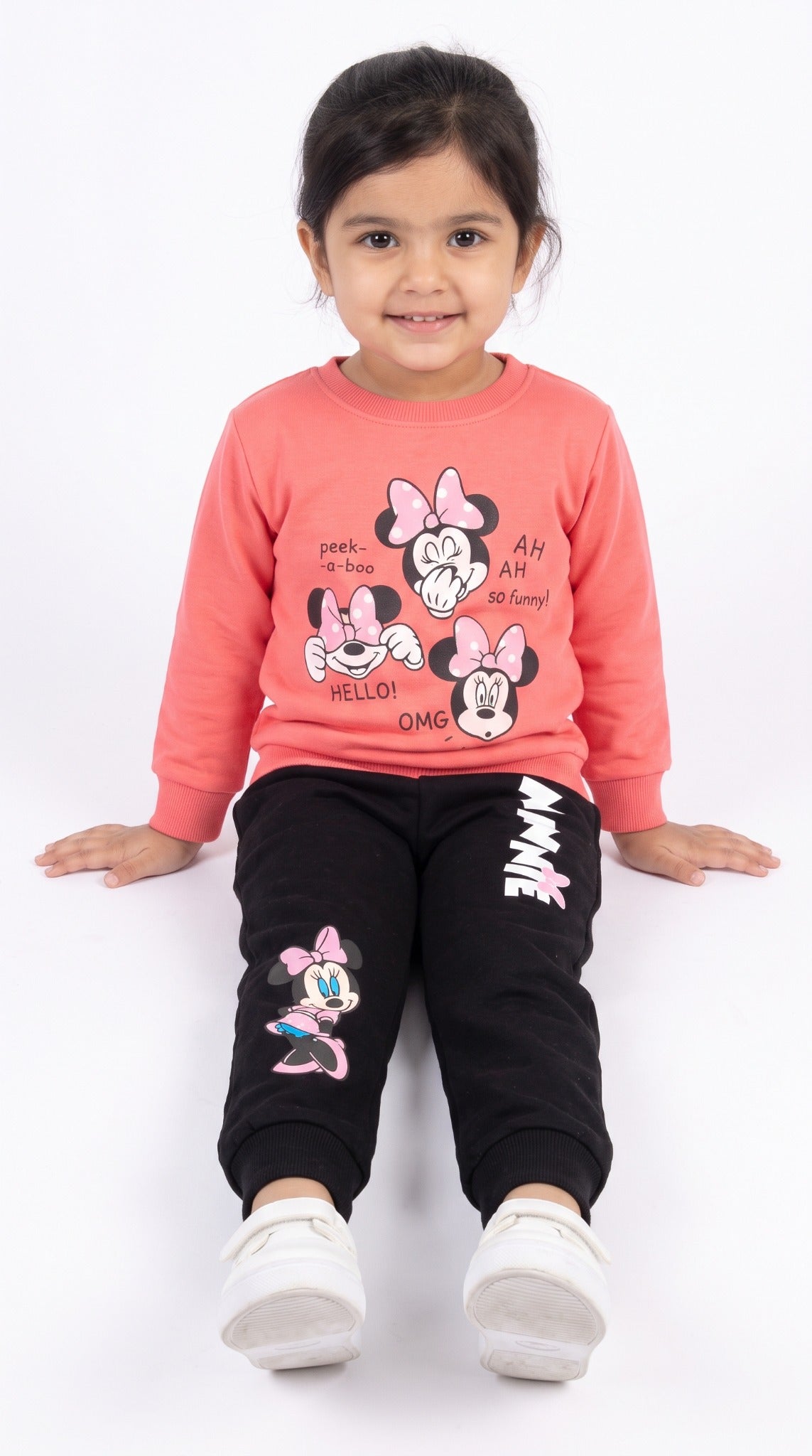 Girls coral and black Minnie tracksuit sitting view