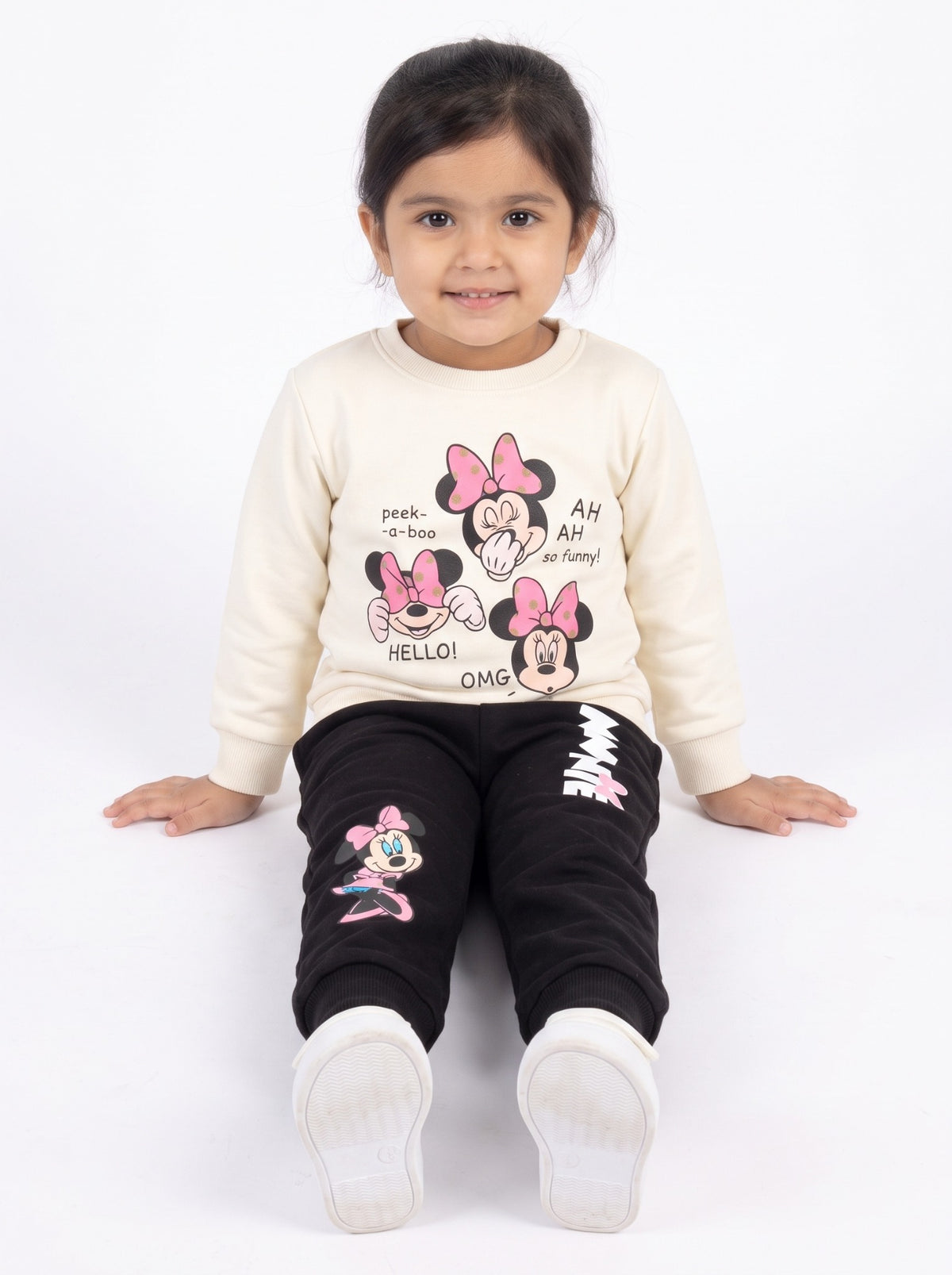Girls cream and black Minnie tracksuit sitting view